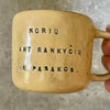 Yellow mug with sweet words in Lithuanian