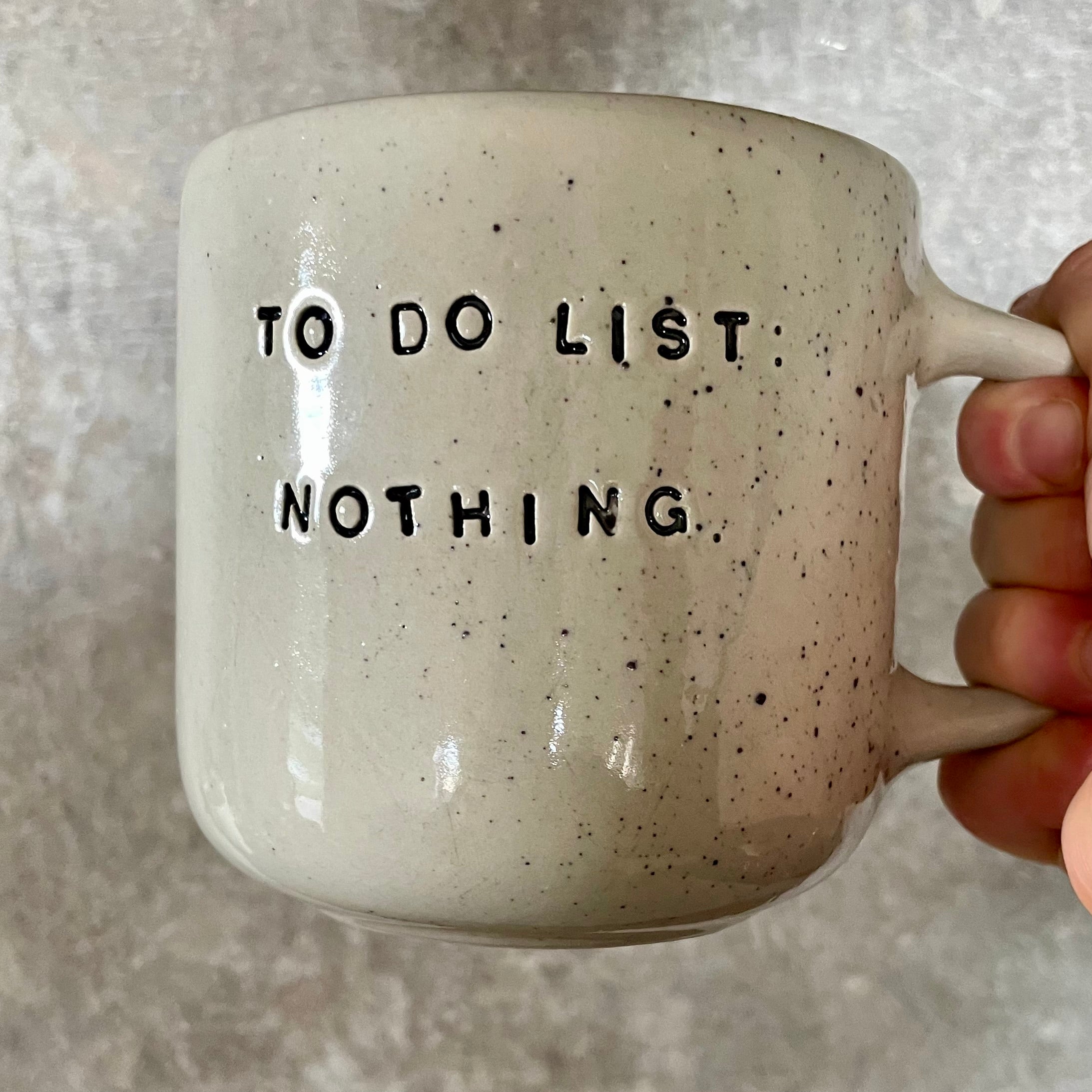 Speckled mug with cozy saying