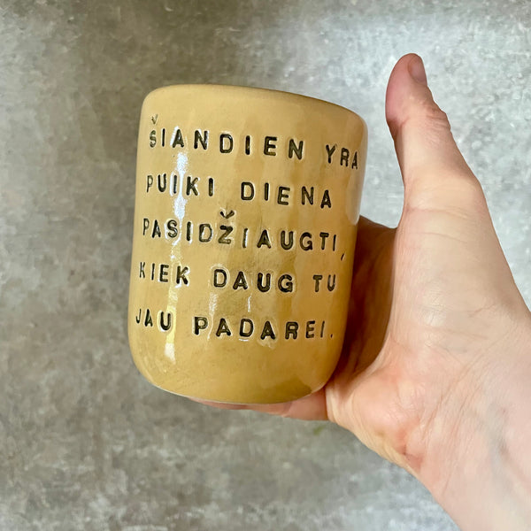 Yellow mug with optimistic text