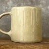 Cozy greenish mug with saying in Lithuanian