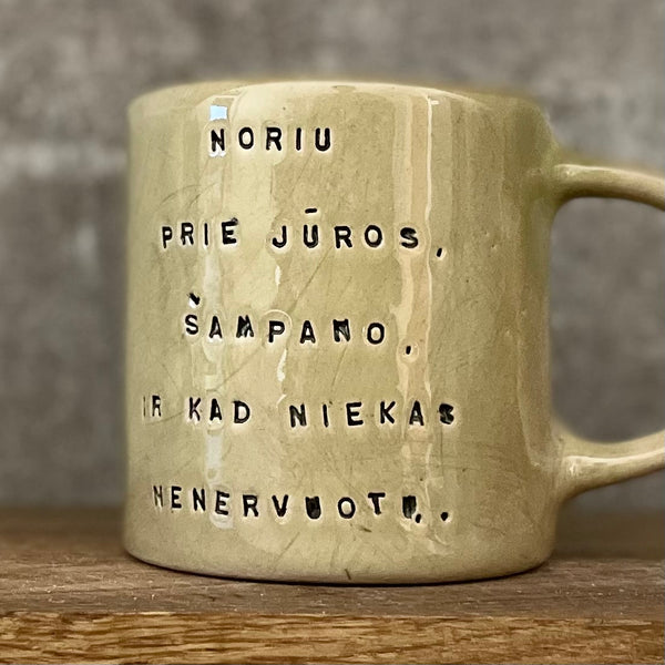 Cozy greenish mug with saying in Lithuanian