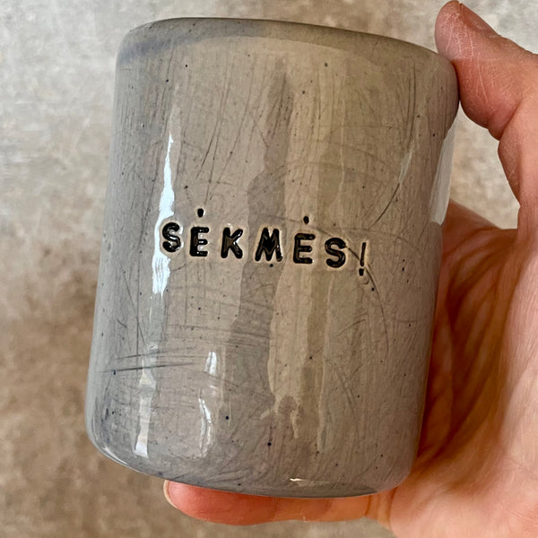 Blue ceramic tumbler mug with word SĖKMĖS